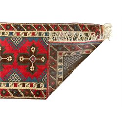 Turkish red ground runner, the field decorated with seven geometric star motifs, repeating geometric patterned border
