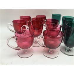Collection of 19th century coloured glasses, to include nine cranberry glass punch cups, each with clear glass handle and foot and a set of six green glasses, with short clear stems, tallest H10cm