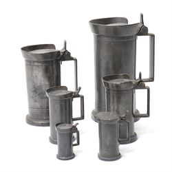 Set of six Continental 19th century graduated pewter lidded measures, each of cylindrical ...