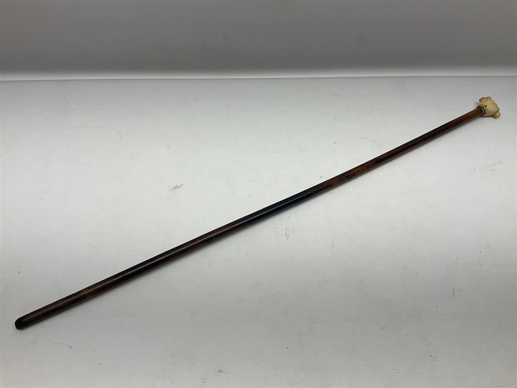 19th century malacca walking cane with scrimshaw handled in the form of a clenched fist holding a scroll, H86cm 