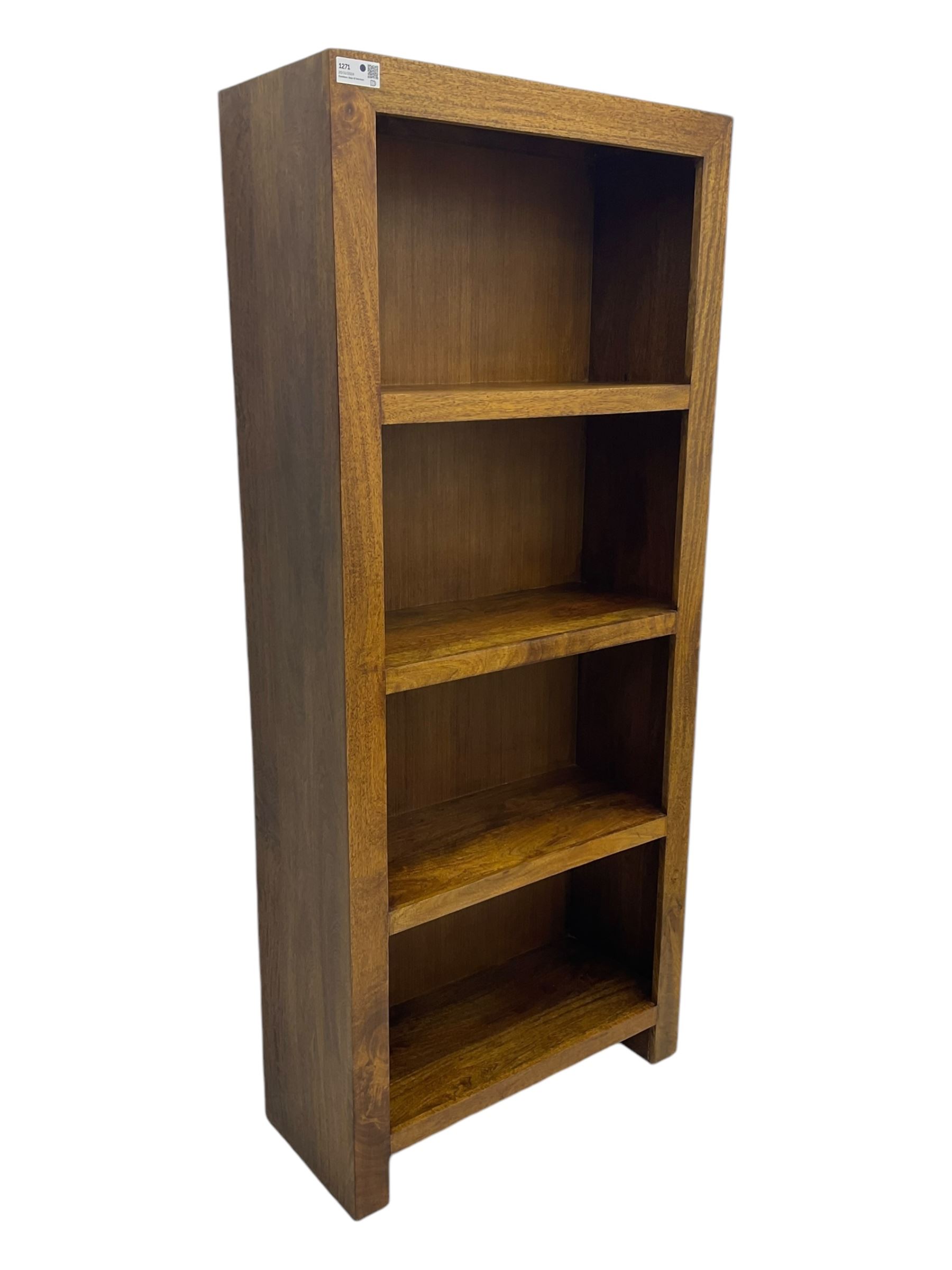 Contemporary Dakota mango wood open bookcase, rectangular form with four fixed open shelves, raised on stile supports