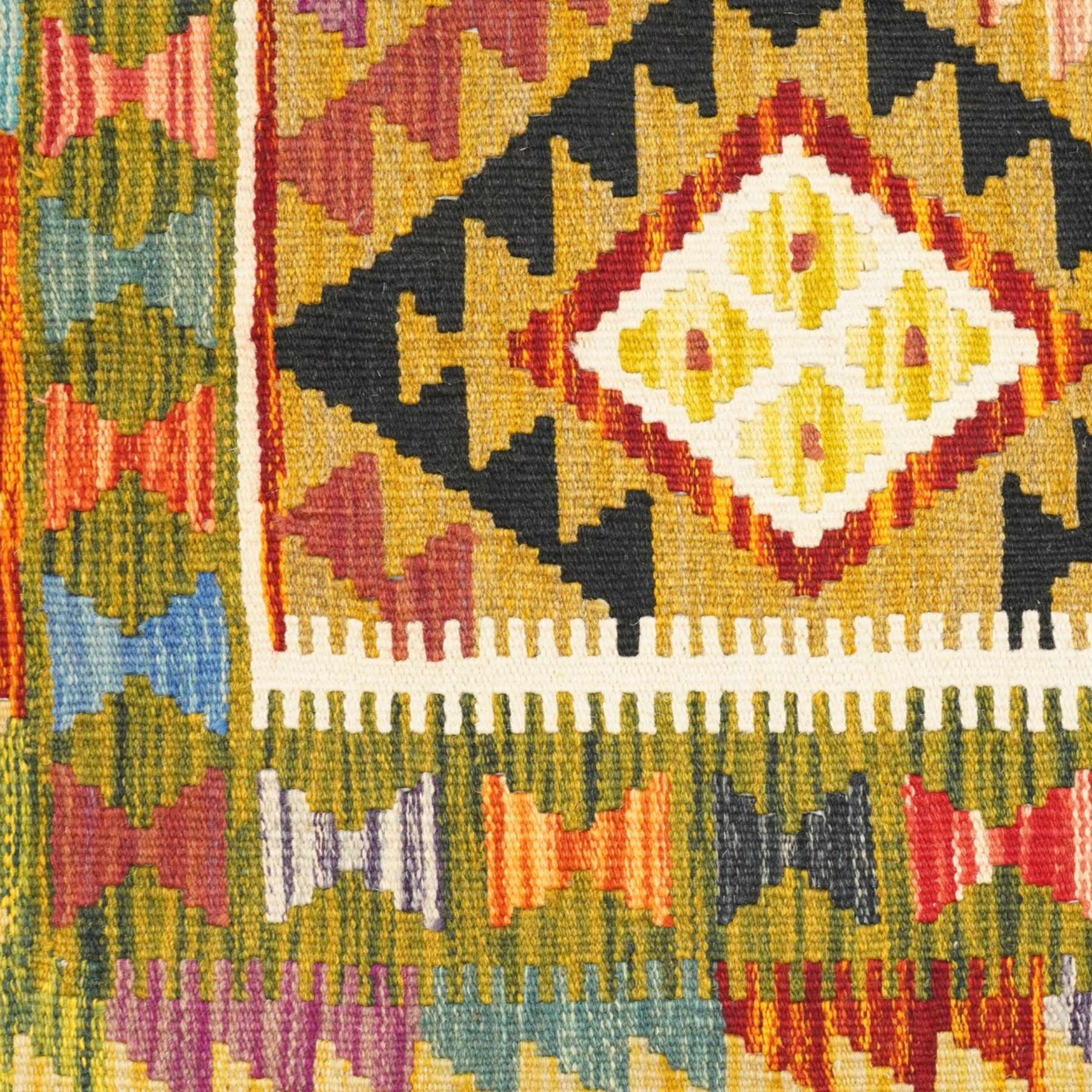 Afghan Maimana flatweave kilim runner, central field features large bold nested diamond motifs and stylized geometric lozenge patterns on olive purple, blue, and green tone ground, border stripe in mustard ground, and fringe