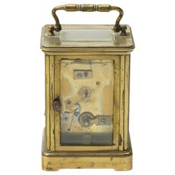 Two early 20th century 8-day French Carriage clocks- one with its original traveling case, lever platform escapement, enamel dial and Roman numerals, the other with a cylinder platform escapement, enamel dial with Roman numerals and five minute Arabic's.  