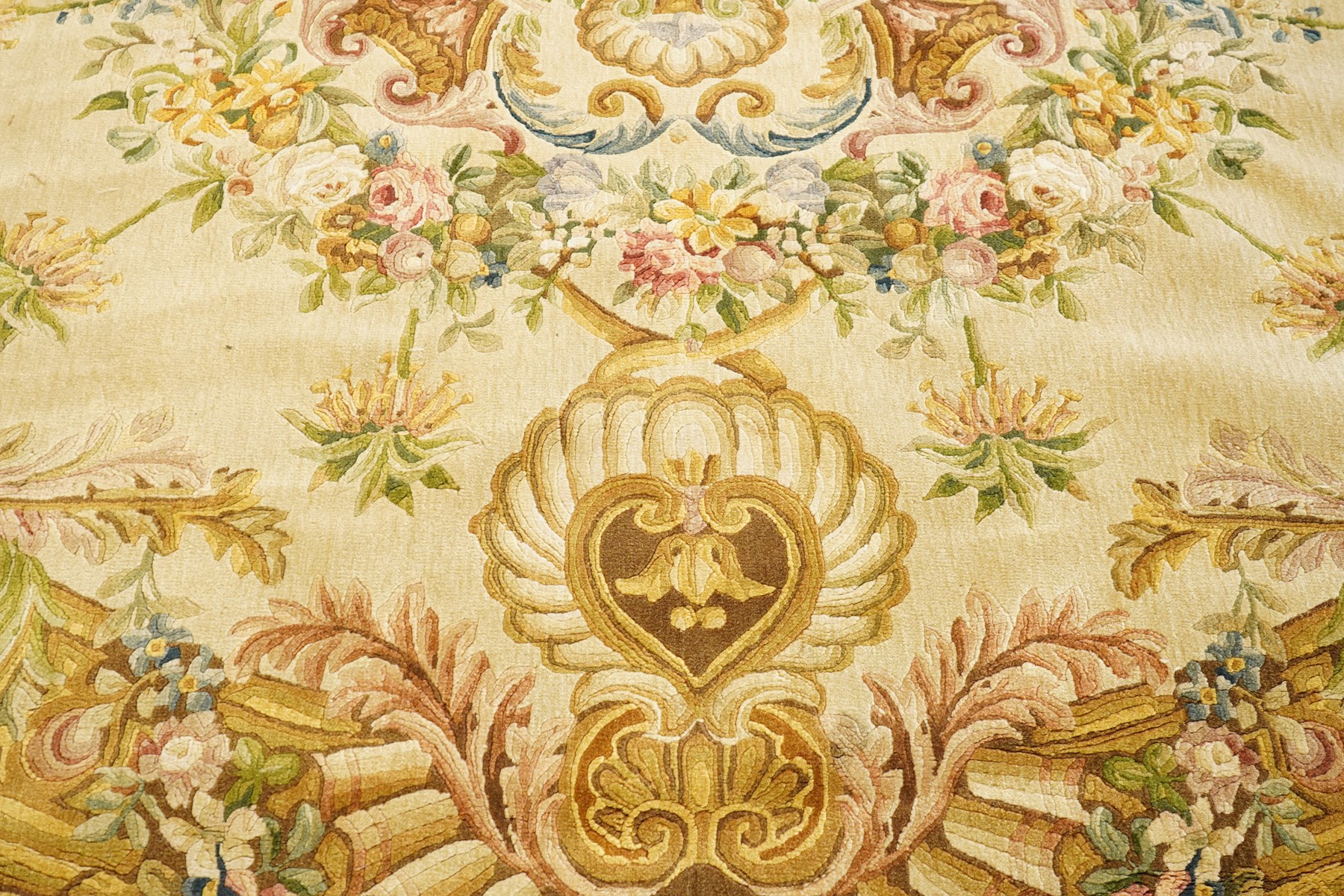 20th century French Aubusson style circular carpet, cream ground of Savonnerie design with scrolling floral and scallop motifs