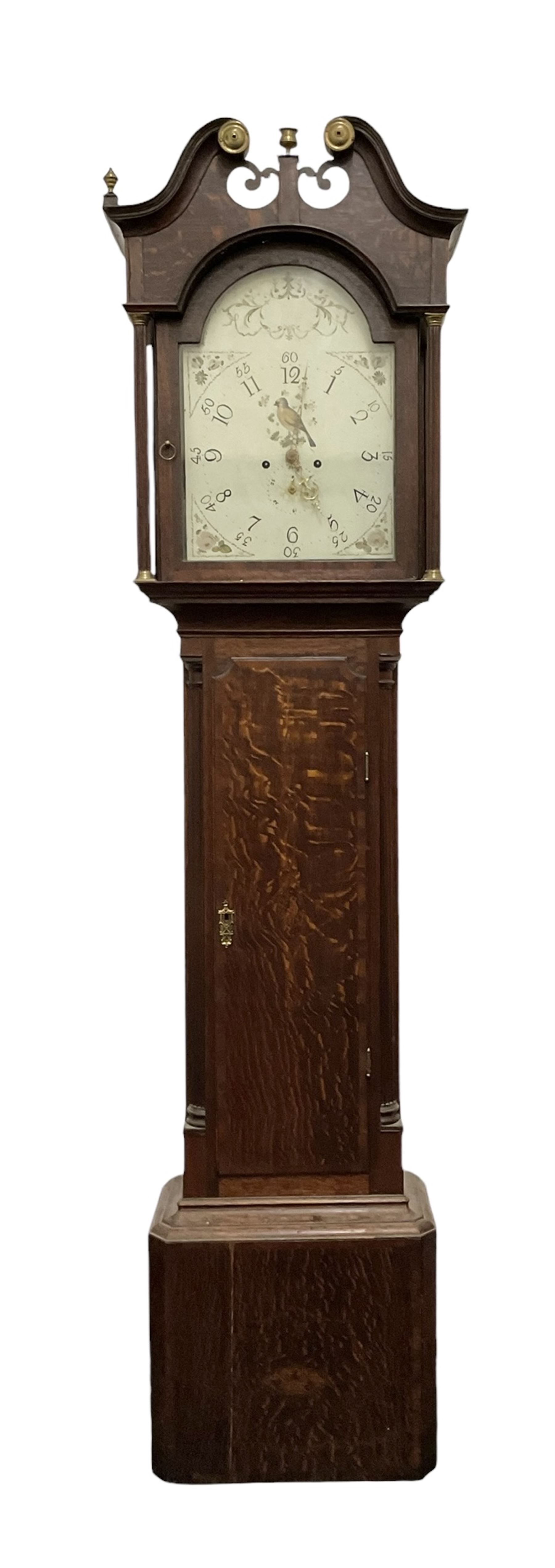 Late 18th century oak 8-day longcase clock, with a swan necked pediment and brass paterie, 
break arch hood door flanked by detached reeded pilasters, trunk with recessed quarter pillars and a long flat topped door, on a square plinth with canted corners, early painted dial with Arabic numerals and floral decoration to the arch and spandrels, with stamped brass hands and date recorder, weight driven two train movement with baluster movement pillars and an internal countwheel strike (bell missing). With pendulum and weights.  No makers name.