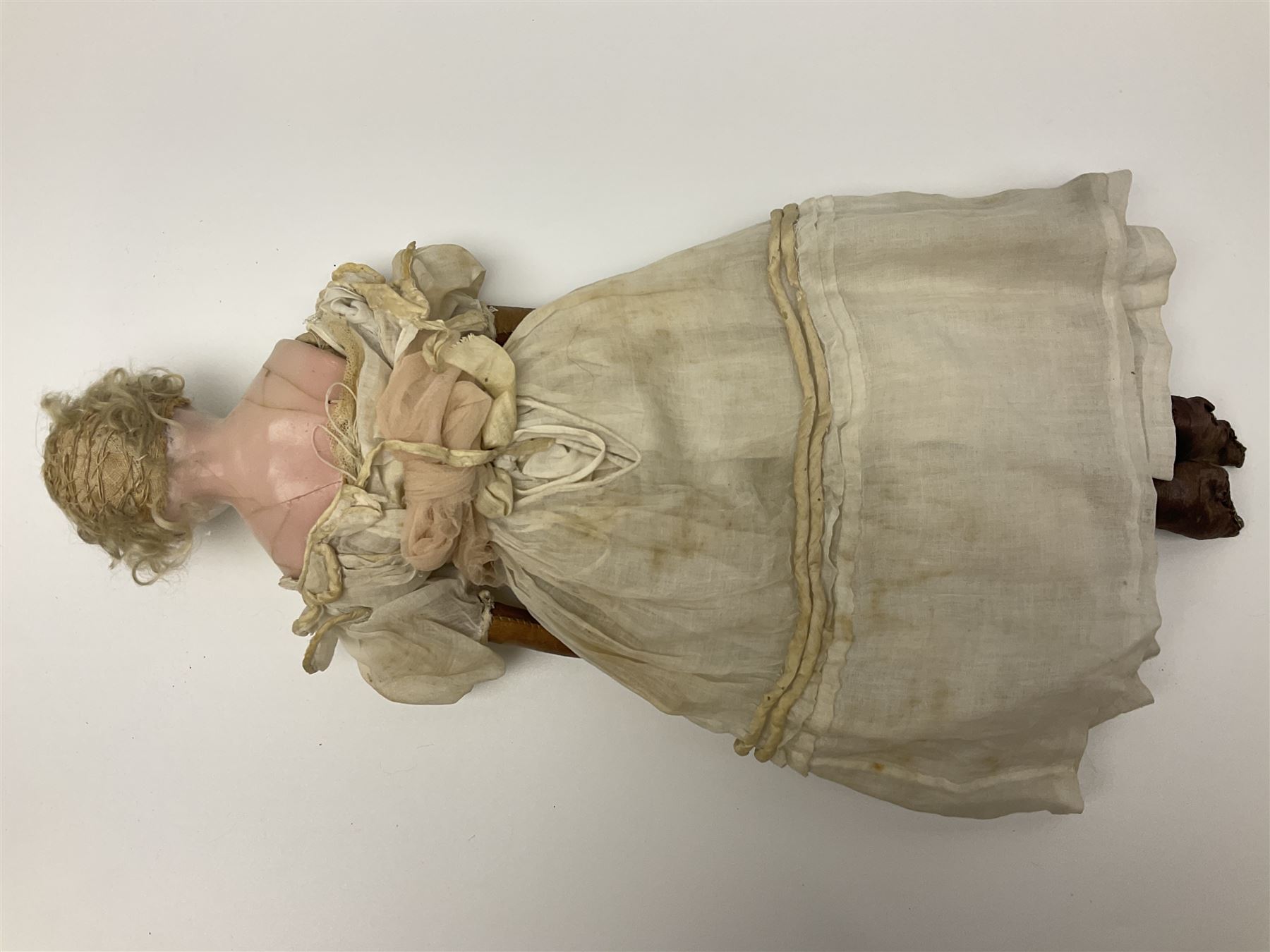 Victorian wax shoulder head doll with pale complexion, applied hair, inset glass eyes and fabric covered jointed body with kid leather lower arms; white linen dress and undergarments H50cm