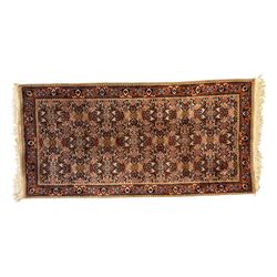 Persian-style wool rug, cream field with floral and geometric motifs, wide floral border (74cm x 142cm); Persian wool rug, beige field with dense floral patterns, narrow floral border (70cm x 144cm); Tribal wool rug, red and navy with diamond motifs (96cm x 60cm); Persian pictorial wool rug, black field with vase, birds, and floral border (70cm x 73cm)