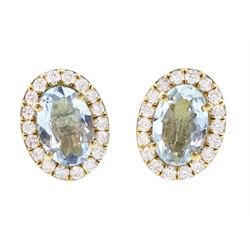 Pair of 9ct gold aquamarine and diamond earrings, each stud set with an oval cut aquamarin...