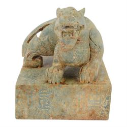 Large 20th century Chinese patinated hardstone dragon seal, the square seal with incised characters to sides and underside, surmounted by the figure of a dragon, H15cm W13cm D13cm