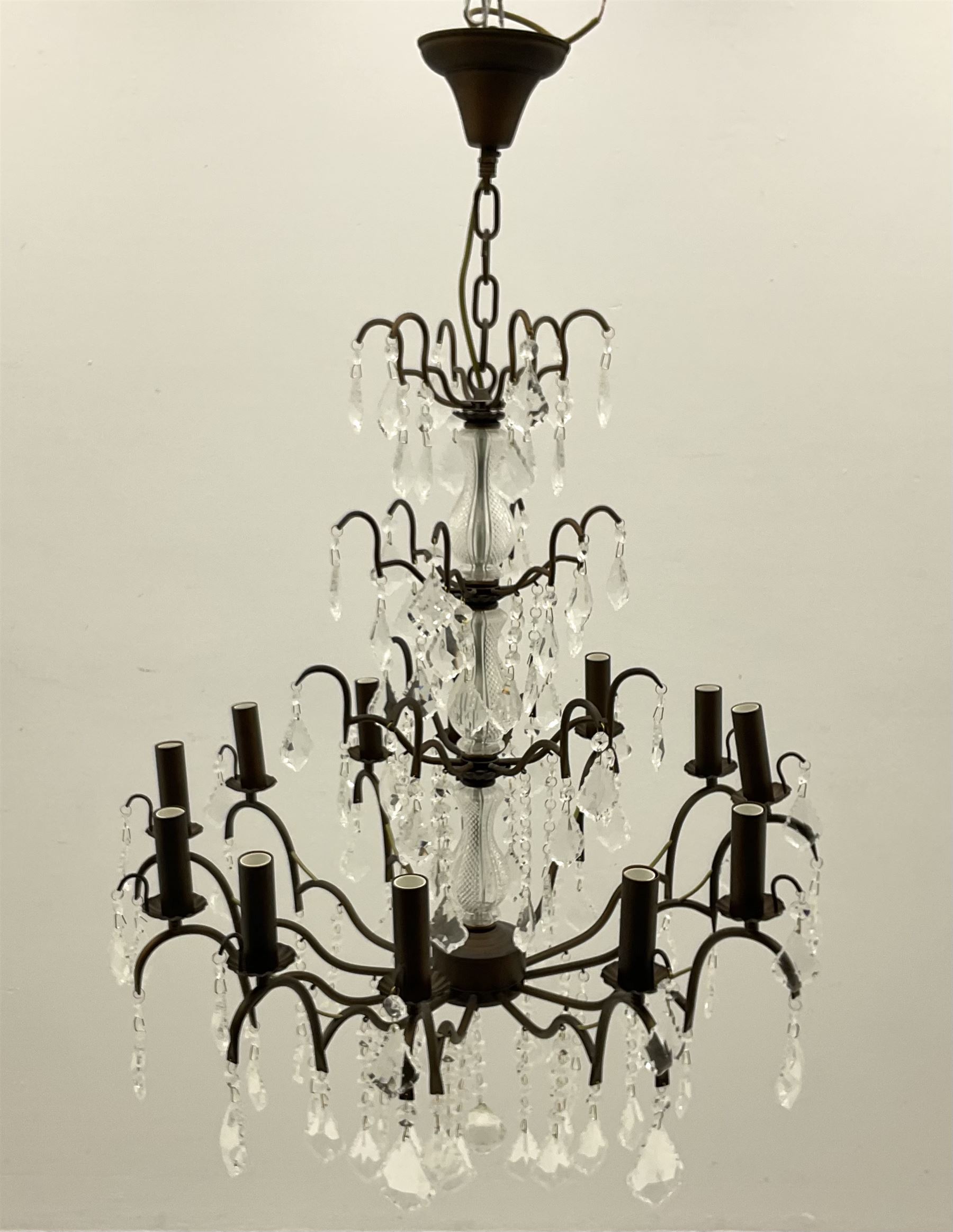 Contemporary bronze finish twelve branch chandelier, decorated with glass droplets 