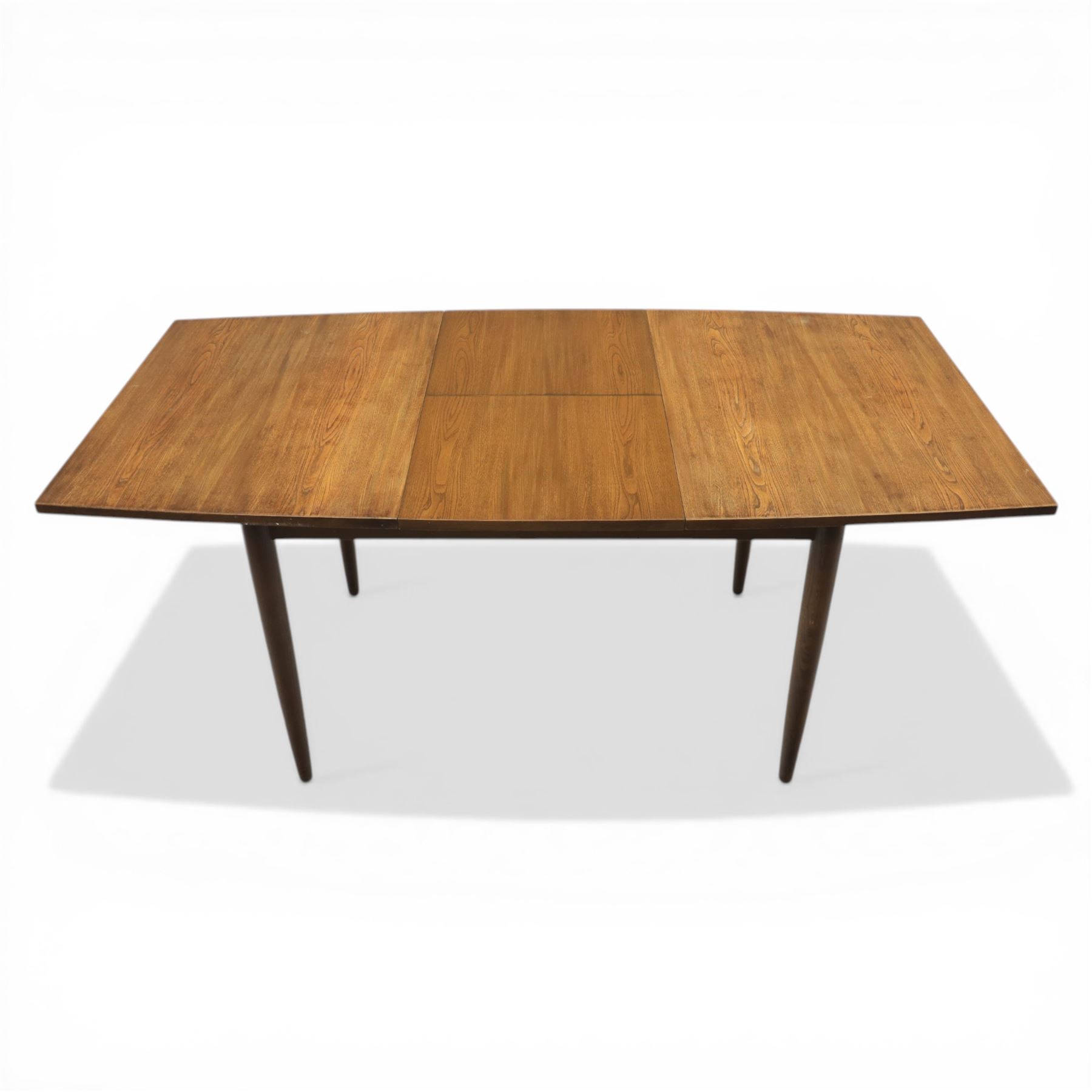 Ensign - Mid-20th century elm extending dining table, with fold out leaf, bow ends and sides; and four low stick back chairs, labelled Ensign Bristow & Townsend Ltd, extended 168cm