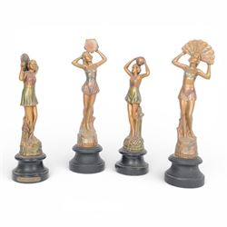 Four Art Deco style figures, modelled as dancers in various poses, finished in gilt and up...