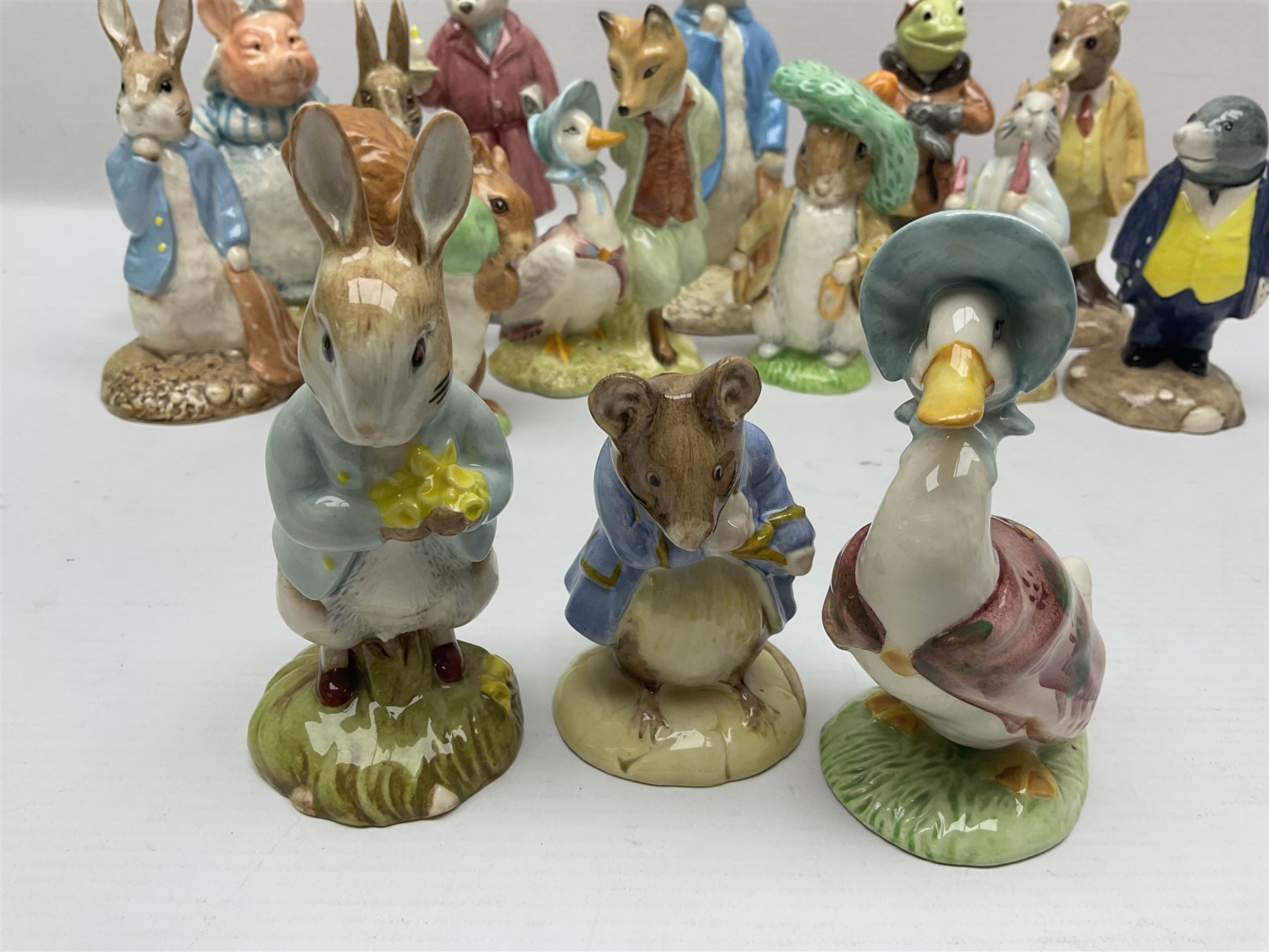 Sixteen Royal Albert Beatrix Potter figures, including Poorly Peter Rabbit, Jemima Puddle Duck and Squirrel Nutkin etc, all boxed together with a Beswick Beatrix Potter Jeremy Fisher miniature jug and four Beswick Wind in the Willows figures 