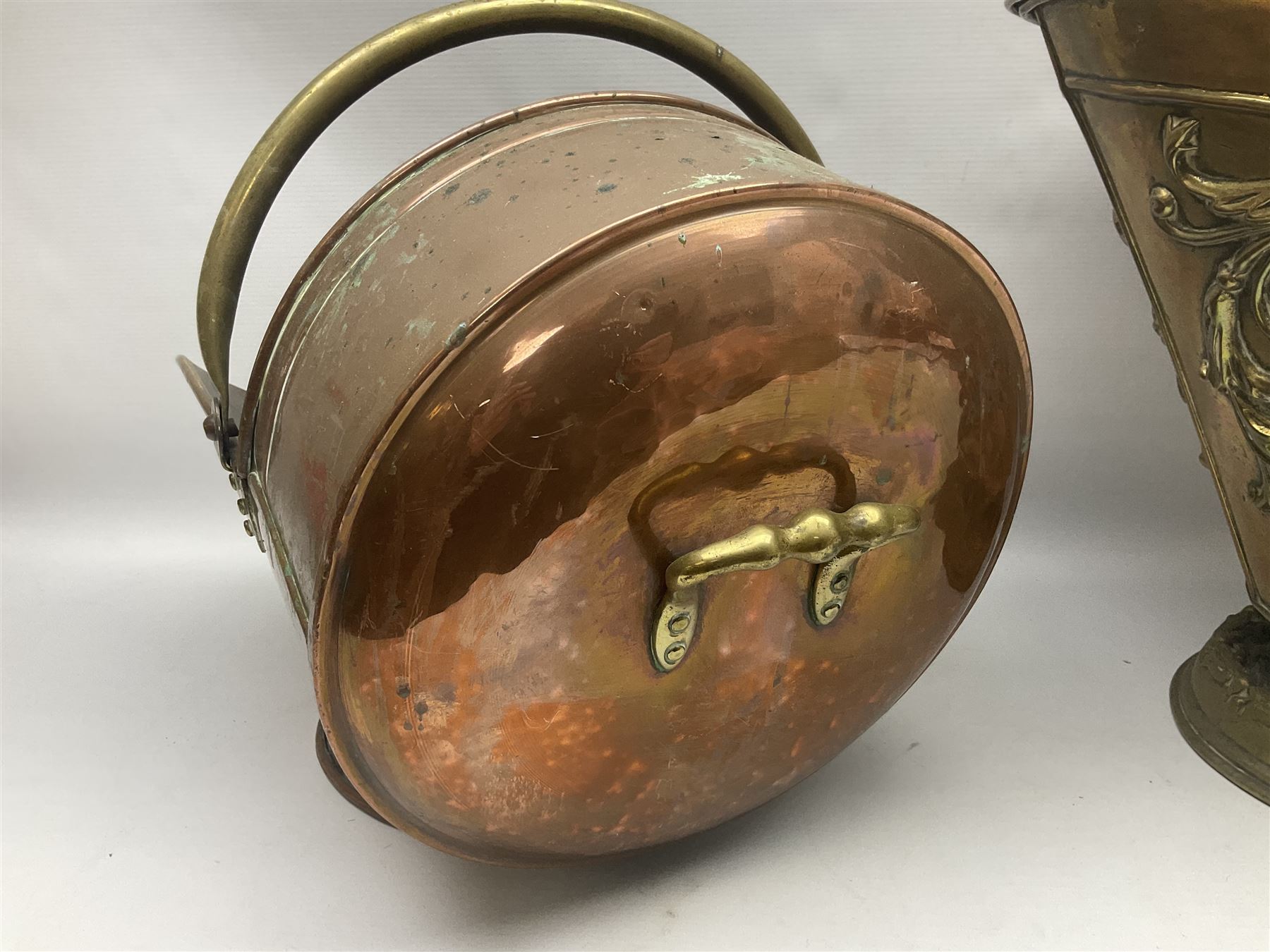 Victorian Benham & Froud Arts and Crafts brass coal scuttle, with Victorian diamond registration mark, together with a copper and brass scuttle of helmet form, tallest H50cm