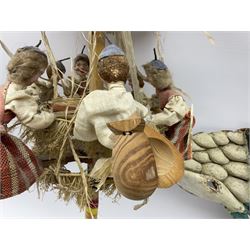 Mid 20th century Brinquinho folk art instrument from Madeira, Portugal, with wood dolls dressed in traditional costume with castanets and bottle caps, L94cm, together with a green, black and white festival mask