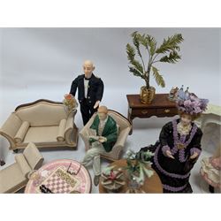 Dolls house furniture, including sofa, chairs, foot stools, fireplace, sideboards, five figures, mirrors, paintings and accessories
