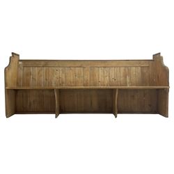 Early 20th century pine church pew, vertical plank back over rectangular seat, flanked by shaped end supports, with bible rest to back