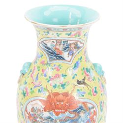 19th century Chinese famille rose yellow ground porcelain vase, of baluster form with twin applied mask ring handles, the body decorated with two shaped reserves mounted with dragon heads, depicting warriors at battle and at court, the neck with two smaller conforming figural reserves, upon a yellow ground decorated with exotic birds amidst scrolling blossom, H45.cm