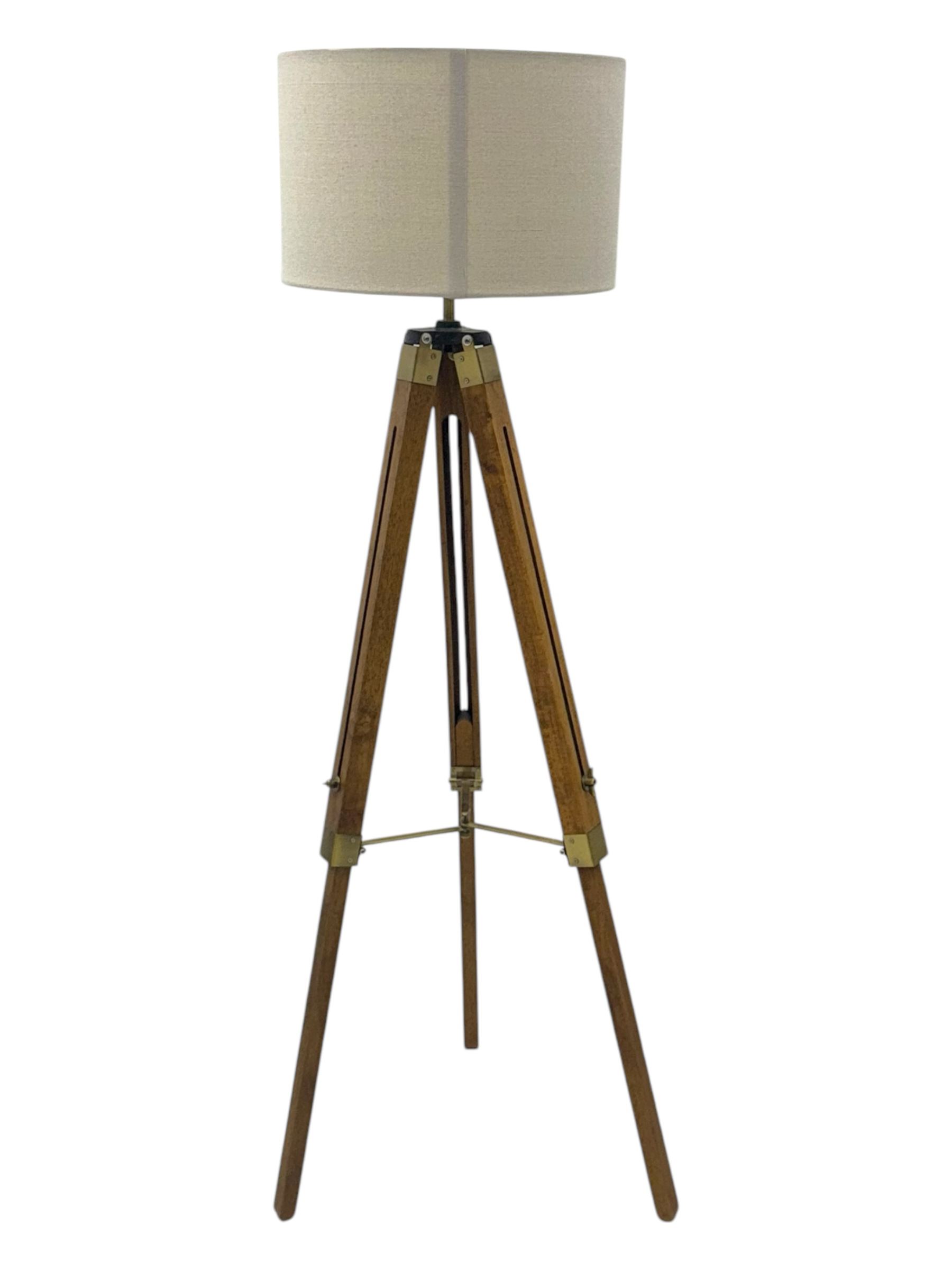 Wooden framed tripod standard lamp, with shade on adjustable legs with brass fititngs