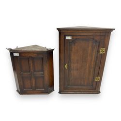 Early 20th century wall mounted oak corner cabinet, moulded cornice over panelled door enclosing single fixed shelf (W60cm, D40cm, H66cm); 19th century oak corner cabinet, panelled door enclosing three shaped shelves (W65cm, D35cm, H92cm)