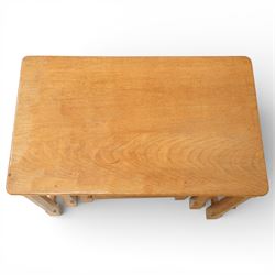 Mouseman - oak nest of three tables, raised on octagonal supports, with carved mouse signature, by the workshop of Robert Thompson of Kilburn