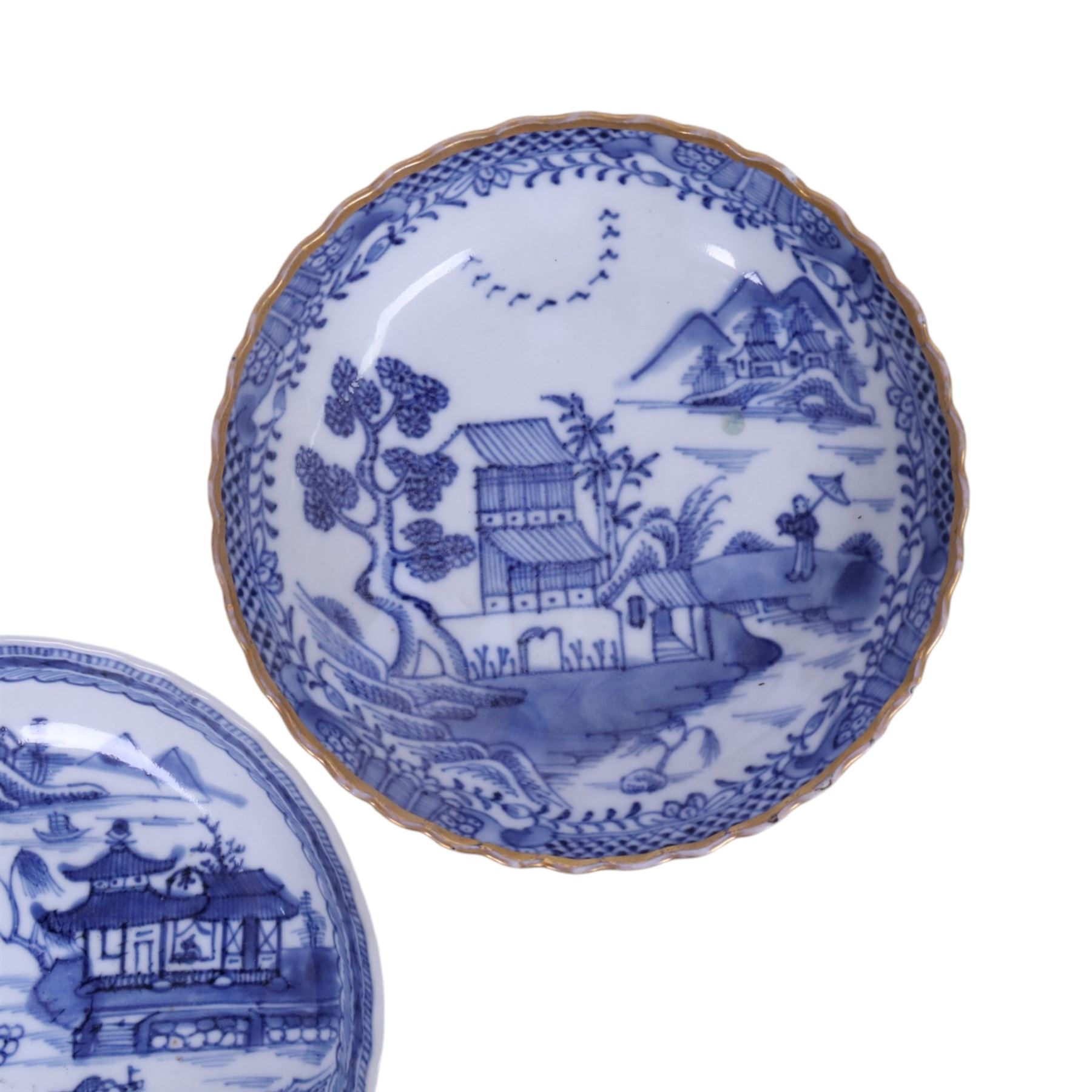 Two 19th century Chinese blue and white tea bowls, each decorated with traditional landscapes, together with two similar saucers, tea bowl H5cm, D9cm  