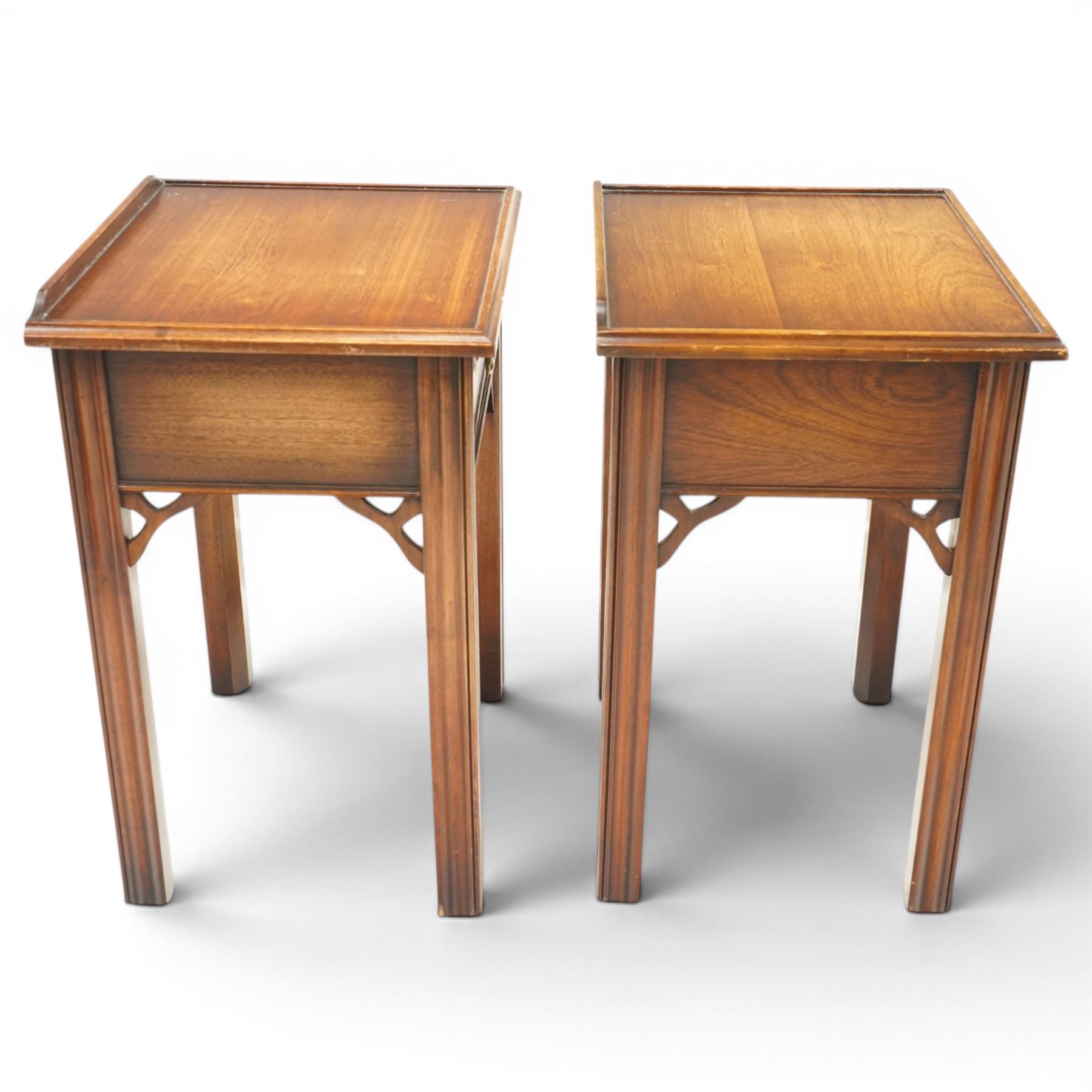 Pair of mahogany bedside tables, with quarter galleried top, single drawer with brass swan neck handle, pierced spandrels on fluted square supports  