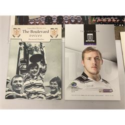 Hull F.C. memorabilia; Clive Sullivan 1986 memorial game programme, Open Evening 1994 programme with multiple player signatures, 'Old Faithful' 45rpm record, Wembley rosettes, 2000 team poster with facsimile signatures, framed print 'Farewell to the Boulevard 1895-2002', fully signed team photograph, various booklets, CD, DVD etc; and a folder containing the Merlin Rugby League card collection