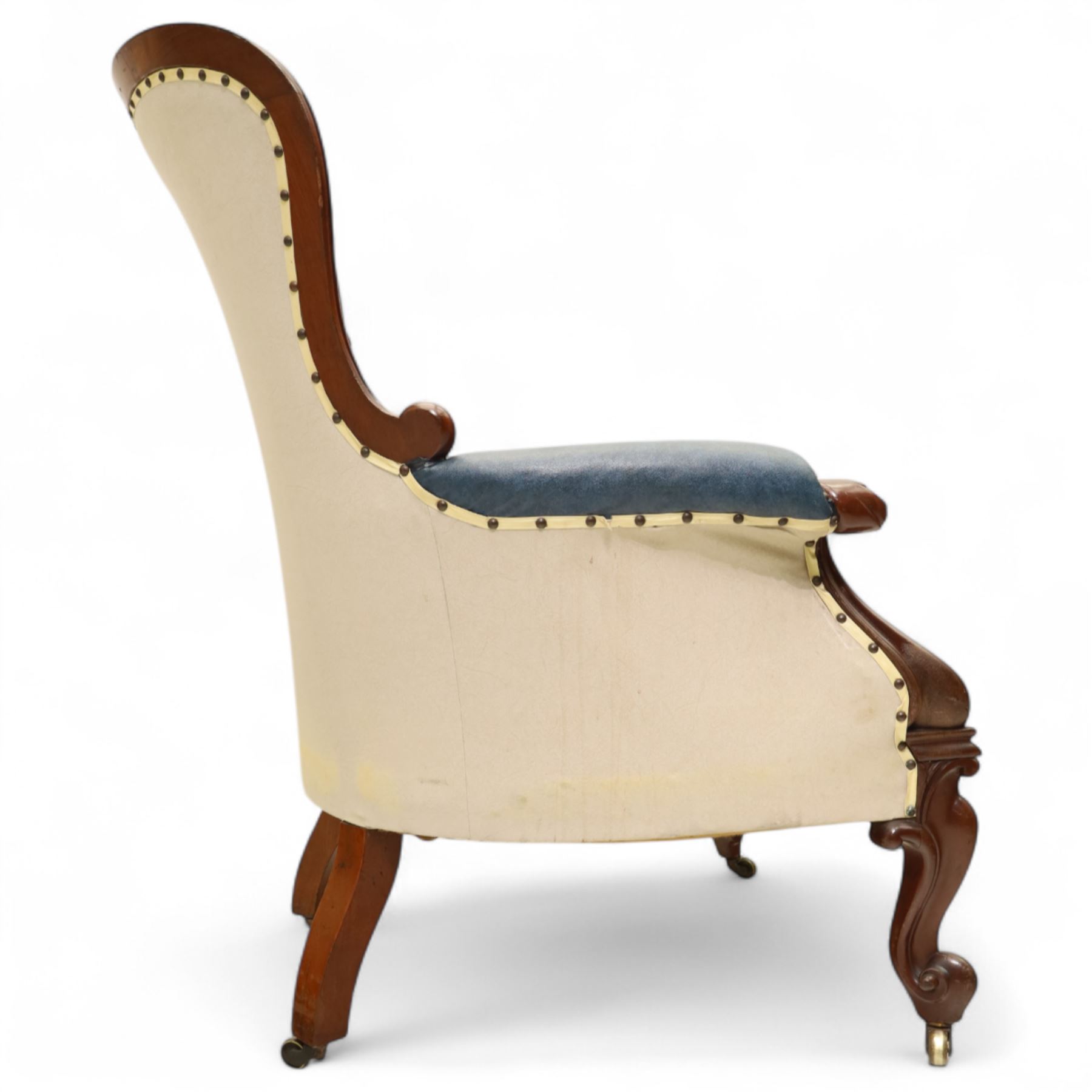 Fine pair of mid-19th-century mahogany library armchairs, carved frame with balloon-shaped back with scrolled ends, rolled wide arms, ending in a scrolled volute above a serpentine seat rail, upholstered in mottled turquoise faux leather, button upholstered back, arms, and cushion seat, studded sides and apron, raised on scroll carved front feet and splayed rear legs on castors 