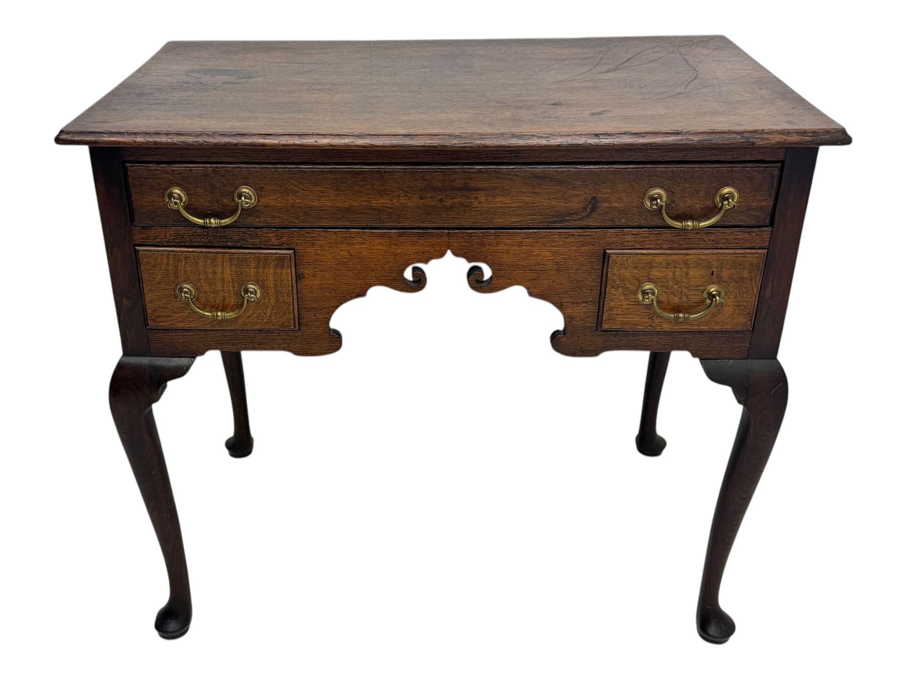 George II oak lowboy, moulded rectangular top over one long and two short drawers fitted with brass drop handles, shaped apron with scrollwork carvings, raised on cabriole supports