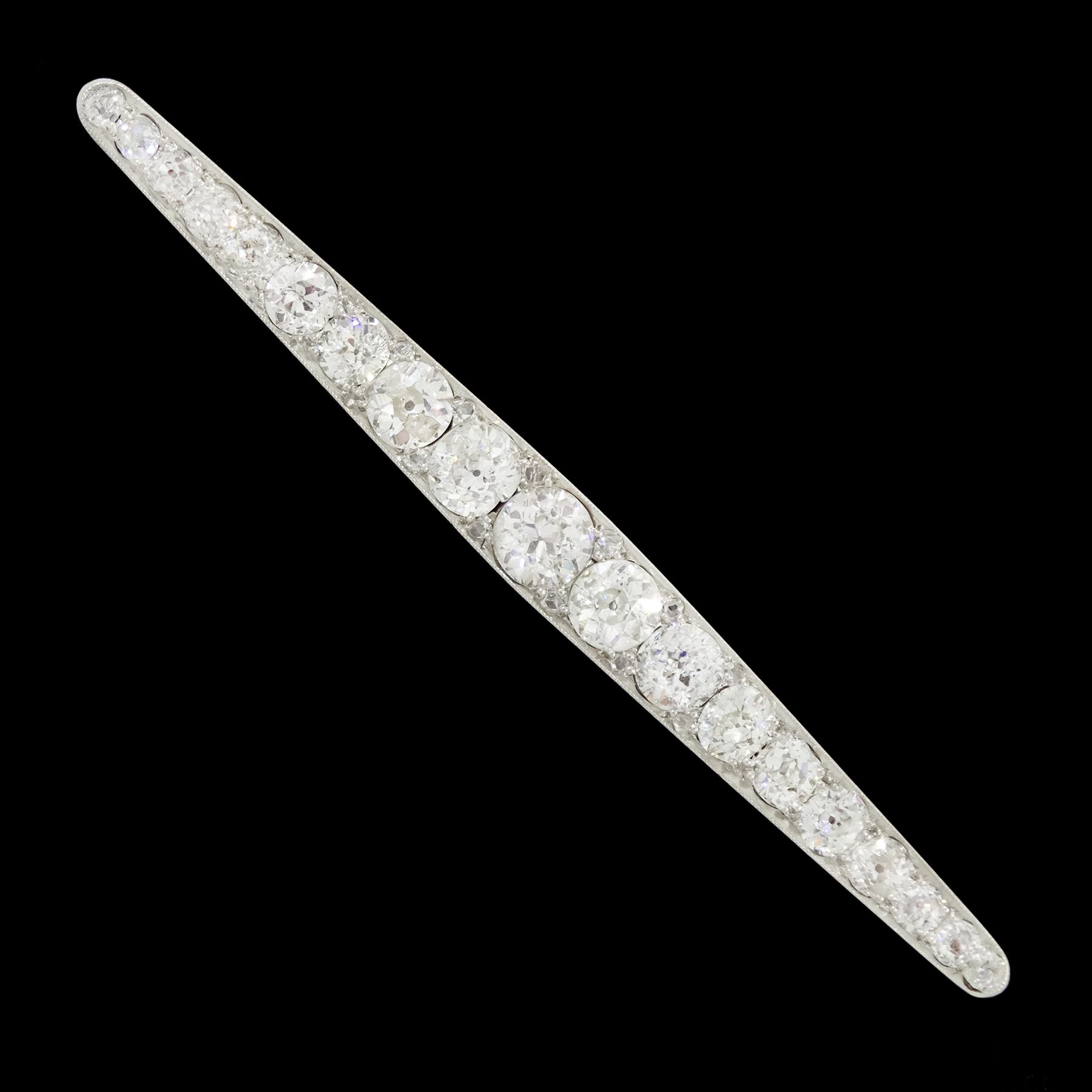 Early 20th century gold and platinum milgrain set graduating old cut diamond brooch, with diamond accents set between, principal diamond approx 0.65 carat, total diamond weight approx 4.75 carat