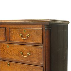Georgian oak chest of drawers, fitted with two short over three long drawers, with brass swing handles and escutcheons, flanked by quarter turned pilasters, raised on shaped bracket feet