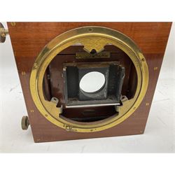 Ensign 'The Sanderson' folding plate camera in mahogany and lacquered brass, field model with canvas wrapped box, two mahogany photographic plates, 'Busch rapid Symmetrical F:8' lens,  and a wooden tripod 