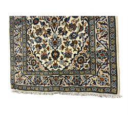 Persian ivory ground runner, the field decorated with six shaped medallions within a field of trailing branches and stylised floral motifs, the guarded border with further floral motifs