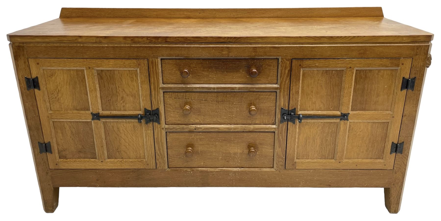 Rabbitman - adzed oak sideboard, fitted with three central drawer and two flanking cupboards, panelled doors with iron latches and hinges, carved with rabbit signature, by Peter Heap, Wetwang