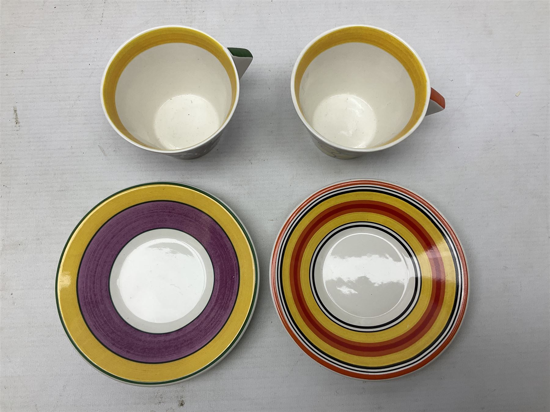 Wedgwood limited edition Clarice Cliff Design Taking Tea collection, comprising eight cups and saucers Honolulu, Apples, Gibraltar, Lilac Crocus, Trees and House, Coral Firs, Devon, and Sunray, with certificates of authenticity 