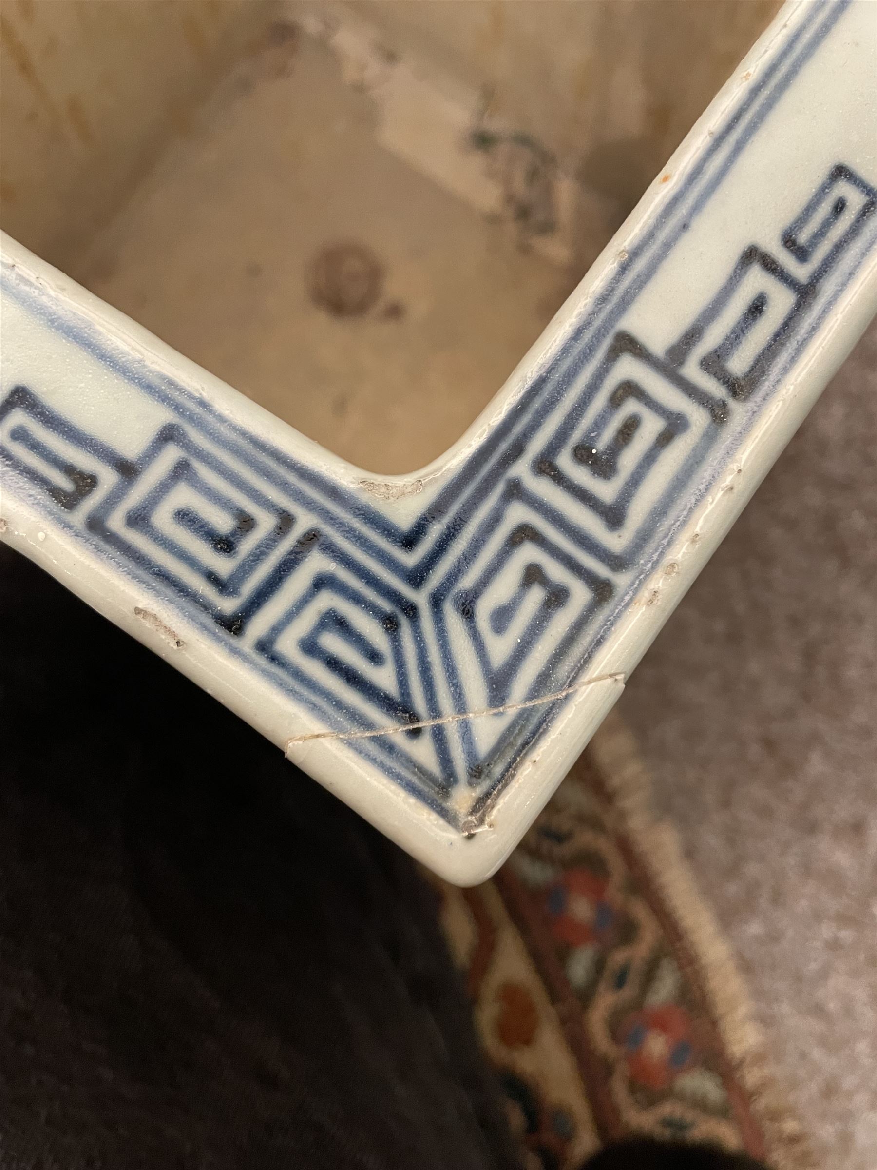19th century Chinese blue and white planter and stand, each of square slightly tapering and flared form, the planter decorated with figures and precious objects between stylised foliate borders, the stand decorated with landscapes beneath a lipped rim with cell band, planter H28cm D25.5cm, stand H7cm D26cm