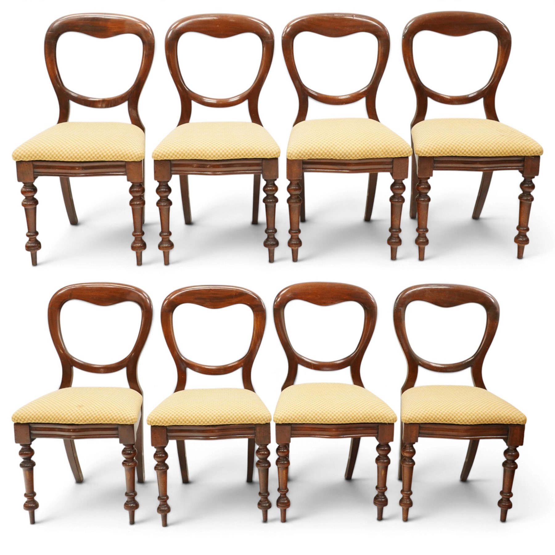 Set of eight mahogany balloon-back dining chairs, drop-in seats upholstered in yellow patterned fabric, raised on turned-front and rear-splayed supports
