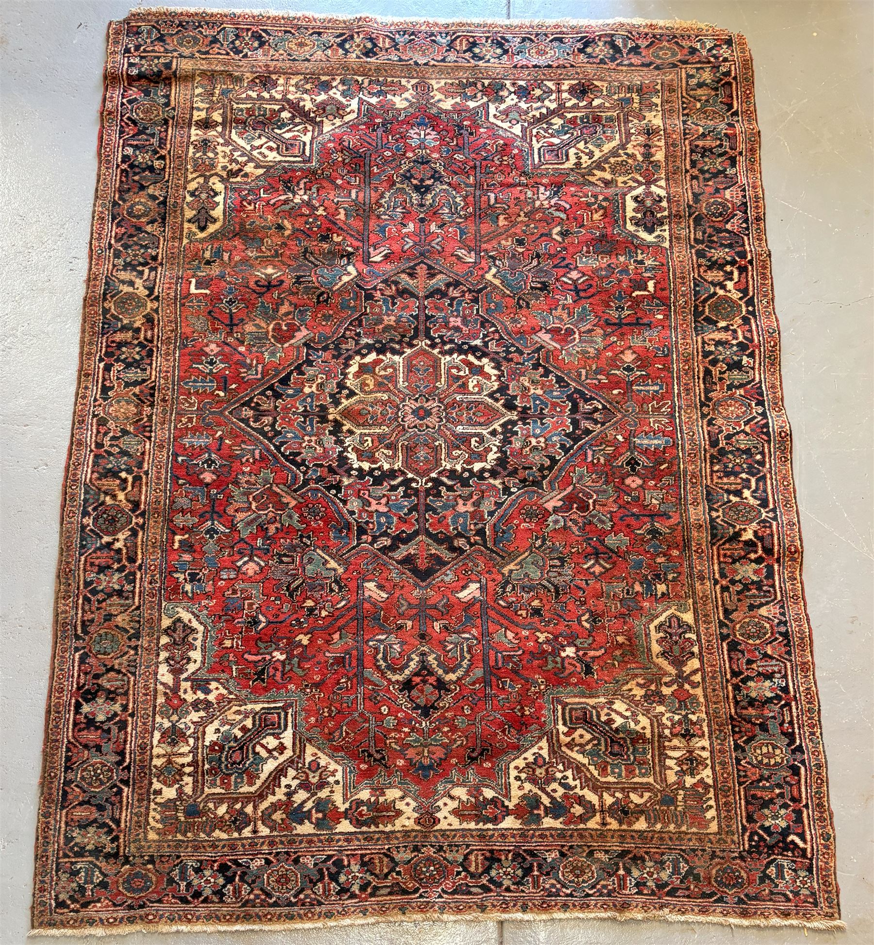 Persian Heriz red ground carpet, the field decorated with all-over geometric floral design within a guarded border, second quarter of the 20th century, 238cm x 339cm. - COLLECTION BY APPOINTMENT FROM: The White House, Thirsk Road, Easingwold, York, YO61 3NF - CALL 01723 507111 TO ARRANGE