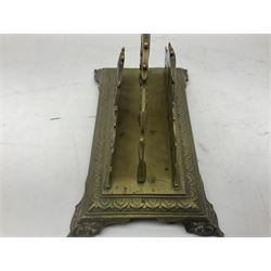 Collection of victorian and later brass desk accessories, to include a letter holder with cherub design, ink well of square form with hinged lid, brass table bell, brass casket with relief decoration, etc  