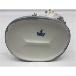 Lladro figure, Bedtime, modelled as a young girl reaching for her pet cat upon grandfather clock, sculpted by Vincente Martinez, with original box, no 5347, year issued 1986, year retired 1998, H28cm