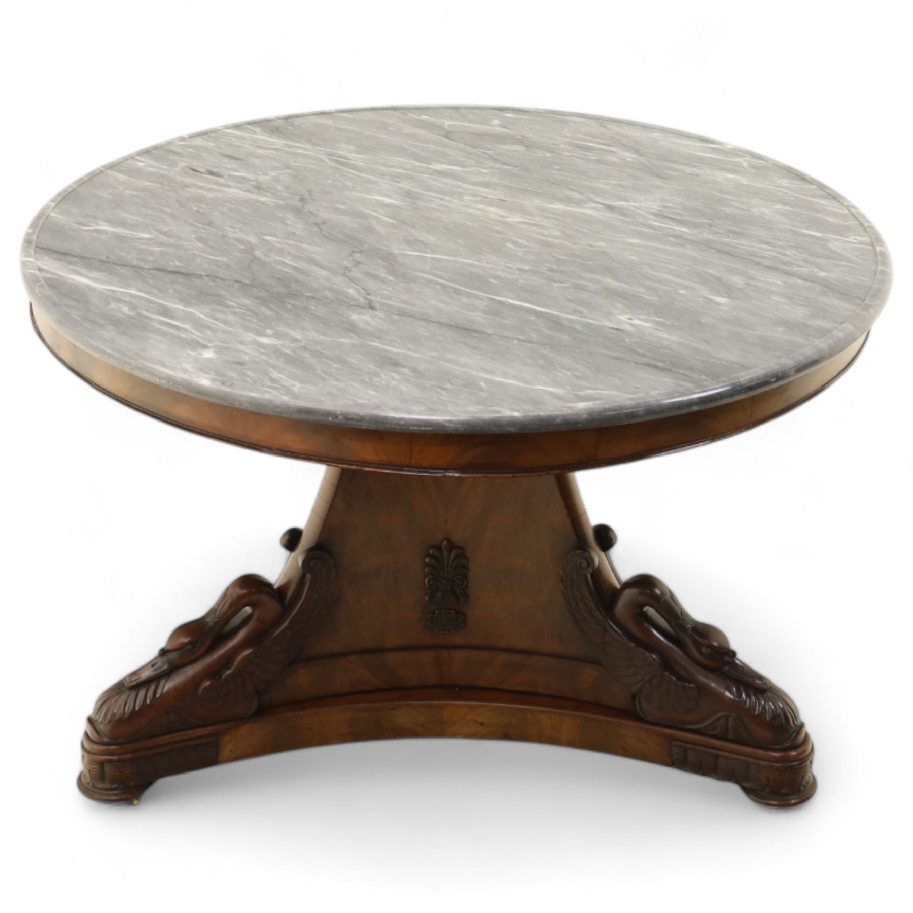 French mid-19th-century Second-Empire mahogany centre table with a dished grey-veined marble top, on a tapered triform pedestal with anthemion brass mounts above carved recumbent swan figures with delicately refined wings and graceful necks curving backwards, associated with the Empress Josephine, raised on three small platform bases