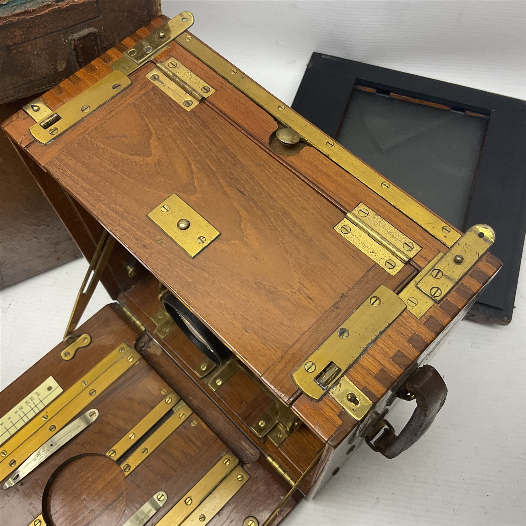 Sanderson Koilos folding plate camera in mahogany and lacquered brass, with 'Ensign Anastigmat Series IV No 2' lens, serial no 173998, with original leather case