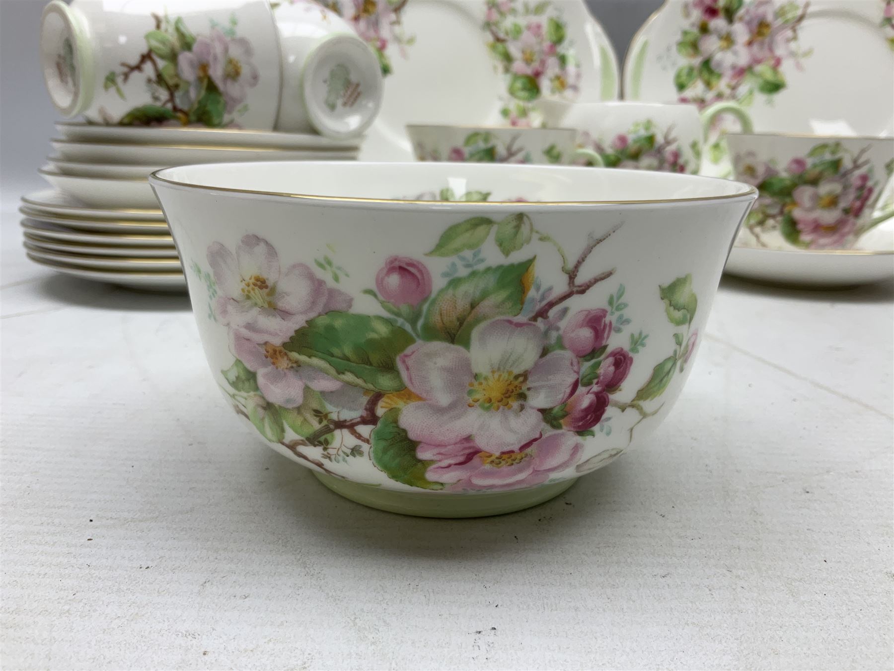 Royal Doulton Apple Blossom pattern tea service for twelve, comprising twelve saucers, twelve tea plates, twelve teacups, milk jug, sucrier and two cake plates