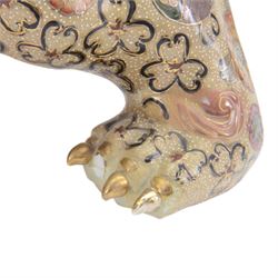 Temple Lion or Dog of Foo, modelled in seated post, one with one front paw resting upon a ball, with sword in mouth, H58cm