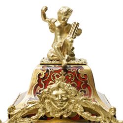 Rollin à Paris - 19th century French Louis XV style ormolu-mounted red tortoiseshell and brass Boulle-work mantel clock, surmounted by a seated musical putto above a waisted case applied with mask, rocaille, foliate and dolphin mounts, the gilt dial with white enamel Roman numeral cartouches, twin-train movement striking on a bell, signed and numbered 480, on four scrolling foliate feet