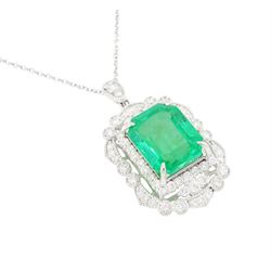 Platinum Colombian emerald and diamond pendant necklace, single octagonal cut emerald of 7.38 carat, surrounded by round cut diamonds in a fancy milgrain pierced design setting, stamped Pt 950, on a trace link chain necklace, total diamond weight 1.14 carat, with GCS certificate