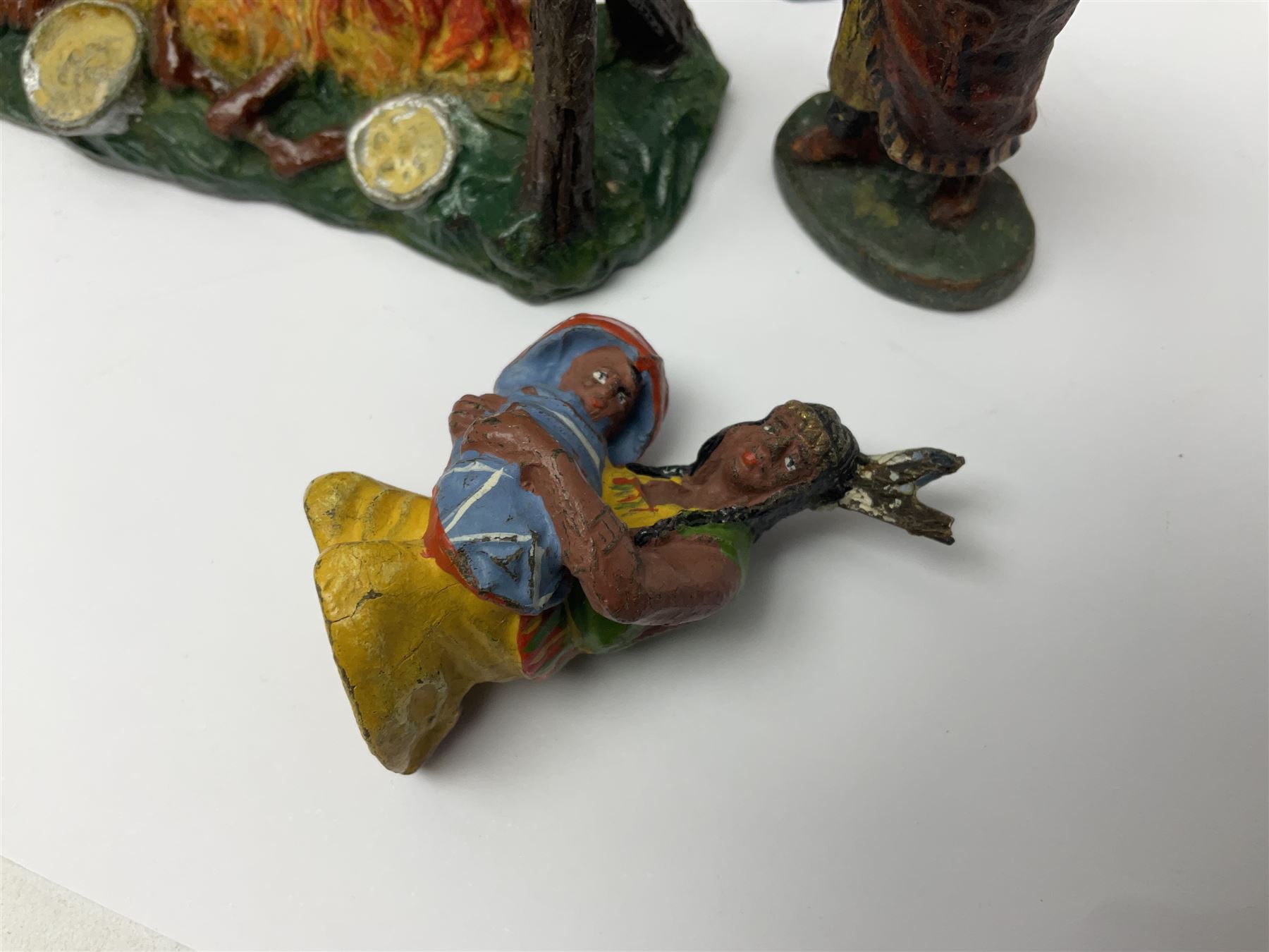 Five Elastolin American Indian figures, together with an Elastolin campfire and a cowboy tied to a tree, tallest H11cm