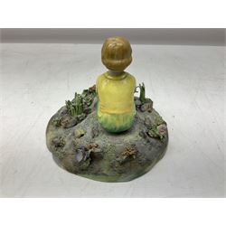 Crown Staffordshire figure modelled as a child in a garden, modelled by T Bayley, H15cm 