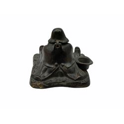 Cast metal inkwell in the form of a man sat eating a roast bird, possibly depicting  Daniel Lambert, H10cm. 